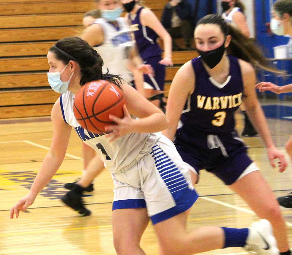 Valley Central’s Emma Rechtorovic dribbles away from Warwick’s Kristen Desrats during Thursday’s girls’ basketball game at Valley Central High School in Montgomery.